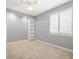 Neutral-toned bedroom featuring built in shelving and shuttered windows at 4521 Cheval Blvd, Lutz, FL 33558