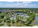 Aerial view of tennis courts and pool, surrounded by lush trees, providing a resort-style experience at 4521 Cheval Blvd, Lutz, FL 33558