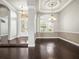 Bright dining room features a tray ceiling, chandelier, wainscoting, and a large window with plantation shutters at 4521 Cheval Blvd, Lutz, FL 33558
