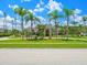 Charming home with lush landscaping, palm trees, and circular driveway, creating an inviting curb appeal at 4521 Cheval Blvd, Lutz, FL 33558
