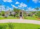Stately home showcases manicured lawn, mature trees, and inviting entryway, creating a warm ambiance at 4521 Cheval Blvd, Lutz, FL 33558
