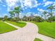 Eye-catching property featuring lush landscaping, circular paved driveway, and manicured lawn at 4521 Cheval Blvd, Lutz, FL 33558