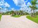 Inviting home with lush landscaping, paved driveway, and well-manicured lawn, exuding elegance at 4521 Cheval Blvd, Lutz, FL 33558