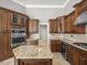 Well-appointed kitchen featuring granite countertops, wood cabinets and island at 4521 Cheval Blvd, Lutz, FL 33558