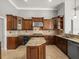 Beautiful kitchen featuring wood cabinets, an island and granite countertops at 4521 Cheval Blvd, Lutz, FL 33558