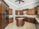 Modern kitchen featuring stainless steel appliances, wood cabinets, and an island at 4521 Cheval Blvd, Lutz, FL 33558
