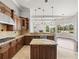 Spacious kitchen features wood cabinets, a granite island, and an open layout at 4521 Cheval Blvd, Lutz, FL 33558