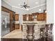 Bright kitchen boasts wood cabinetry, granite countertops, and tiled floors at 4521 Cheval Blvd, Lutz, FL 33558