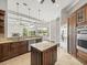 Open-concept kitchen with granite island, wood cabinets, and modern appliances at 4521 Cheval Blvd, Lutz, FL 33558