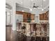 Kitchen with stone-accented island, wood cabinetry, and pendant lighting at 4521 Cheval Blvd, Lutz, FL 33558
