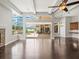 Open living area features wood floors, ceiling fan and views of the backyard and pool at 4521 Cheval Blvd, Lutz, FL 33558