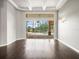 This light-filled room has hard wood floors, a coffered ceiling, and a wall of glass sliding doors at 4521 Cheval Blvd, Lutz, FL 33558