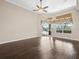 This bright living room offers a ceiling fan, hardwood floors, and multiple windows at 4521 Cheval Blvd, Lutz, FL 33558