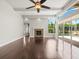 Bright living room with fireplace, ceiling fan, and access to the lanai and screened pool at 4521 Cheval Blvd, Lutz, FL 33558