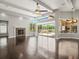 Bright living room with fireplace, ceiling fan, and access to the lanai and screened pool at 4521 Cheval Blvd, Lutz, FL 33558