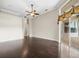 Large living room features hardwood floors, a ceiling fan, and sliding glass doors at 4521 Cheval Blvd, Lutz, FL 33558