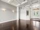 Bright living room featuring hardwood floors, recessed lighting, tray ceiling and an arched entry way at 4521 Cheval Blvd, Lutz, FL 33558