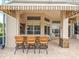 Outdoor bar area with granite counter, seating, and retractable awning at 4521 Cheval Blvd, Lutz, FL 33558