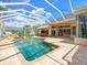 Relaxing pool area with adjacent outdoor kitchen and bar with backyard access and privacy from neighbors at 4521 Cheval Blvd, Lutz, FL 33558