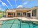 Backyard pool and patio with outdoor bar area and screened enclosure at 4521 Cheval Blvd, Lutz, FL 33558