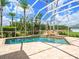 Enclosed pool area featuring brick-paver patio and a beautiful waterfall feature for a relaxing outdoor retreat at 4521 Cheval Blvd, Lutz, FL 33558