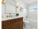 Updated bathroom featuring a dark wood vanity, modern gold fixtures, and a shower-tub combination at 4611 W Bay Court Avenue, Tampa, FL 33611