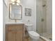 Classic bathroom with tiled shower, wood vanity, and neutral fixtures at 4611 W Bay Court Avenue, Tampa, FL 33611