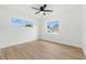 Empty bedroom featuring neutral walls, wood floors, and two windows at 4611 W Bay Court Avenue, Tampa, FL 33611