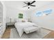 Cozy bedroom with white walls, wood floors, ceiling fan, and natural light at 4611 W Bay Court Avenue, Tampa, FL 33611