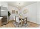 Dining area showcasing table with seating for four adjacent to a stainless steel refrigerator at 4611 W Bay Court Avenue, Tampa, FL 33611