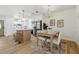 Bright dining area featuring a modern chandelier and light wood table, seamlessly connecting to the kitchen at 4611 W Bay Court Avenue, Tampa, FL 33611