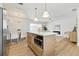 Open-concept kitchen featuring a kitchen island, stainless steel appliances, and view to the dining and living area at 4611 W Bay Court Avenue, Tampa, FL 33611