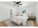 Spacious main bedroom with hardwood floors, large windows, and built-in closet storage space at 4611 W Bay Court Avenue, Tampa, FL 33611