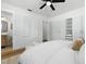 Bright bedroom featuring neutral walls, wood floors, closet, and access to a bathroom at 4611 W Bay Court Avenue, Tampa, FL 33611