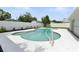 Inviting backyard pool with a white concrete deck, privacy fence, and lush landscaping at 4611 W Bay Court Avenue, Tampa, FL 33611