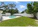 Large backyard pool, grass area and white fence at 4611 W Bay Court Avenue, Tampa, FL 33611