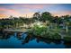 Scenic aerial view of a home near the water with lush green surroundings at sunset at 4915 South Rd, New Port Richey, FL 34652