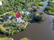 Aerial view of a waterfront estate featuring a private pool, dock, and lush landscaping at 4915 South Rd, New Port Richey, FL 34652