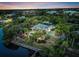 Stunning aerial view of estate, lush greenery, a beautiful home, and a dock on the water at 4915 South Rd, New Port Richey, FL 34652