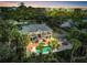 Stunning aerial view of a two-story home with a swimming pool, surrounded by lush greenery and palm trees at 4915 South Rd, New Port Richey, FL 34652