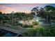 Stunning aerial view of property, featuring a pool, lush landscaping and plenty of privacy at 4915 South Rd, New Port Richey, FL 34652