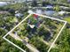 Aerial view of property's location near a large body of water, surrounded by verdant trees at 4915 South Rd, New Port Richey, FL 34652