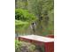 A heron standing on a dock overlooking the waterfront in the backyard at 4915 South Rd, New Port Richey, FL 34652