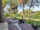 Landscaped backyard featuring a brick patio with fire pit and lush greenery at 4915 South Rd, New Port Richey, FL 34652