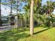 Charming greenhouse in a lush green backyard, perfect for gardening enthusiasts to grow their own food at 4915 South Rd, New Port Richey, FL 34652