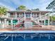 A beautiful view of a two-story home with a large pool, and a well-maintained outdoor space at 4915 South Rd, New Port Richey, FL 34652