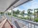 Waterfront view from the balcony with palm trees and a serene lake at 4915 South Rd, New Port Richey, FL 34652