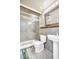 Bathroom with glass enclosed shower/tub, single pedestal sink and tile flooring at 4915 South Rd, New Port Richey, FL 34652