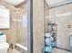 Bathroom featuring a glass shower, toilet, and corner shelf with an assortment of toiletries at 4915 South Rd, New Port Richey, FL 34652