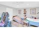 Bedroom with white ceiling fan, wood bed frame, and painted blue bathtub at 4915 South Rd, New Port Richey, FL 34652